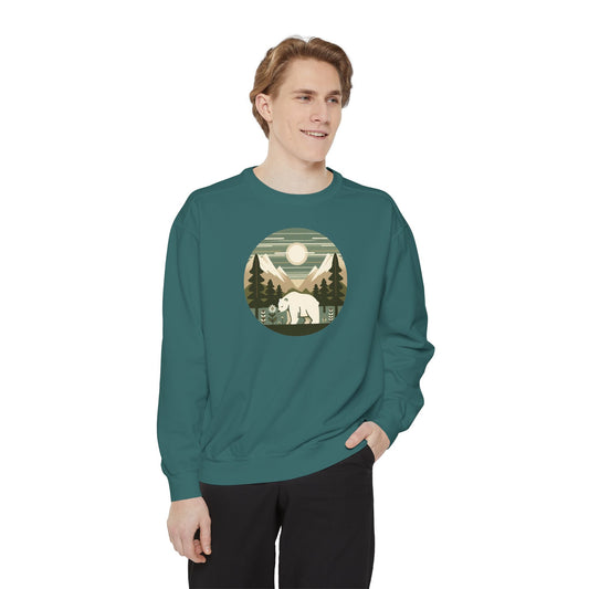 Man wearing a teal sweatshirt with a nature graphic on a white background