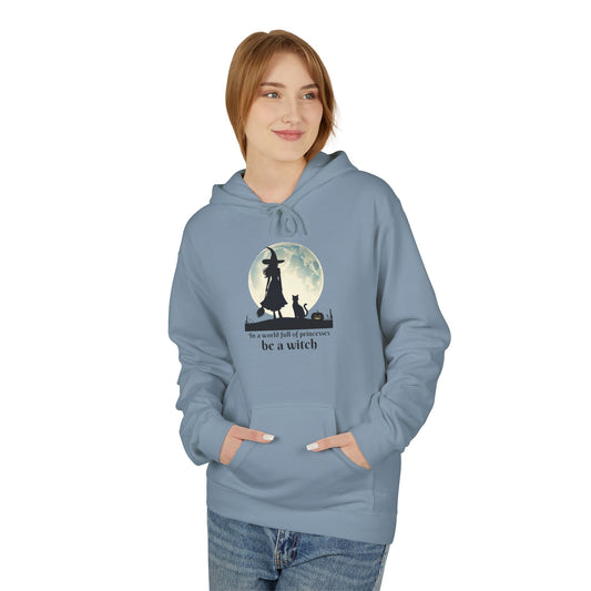 Person wearing a blue hoodie with a witch graphic and text on a white background