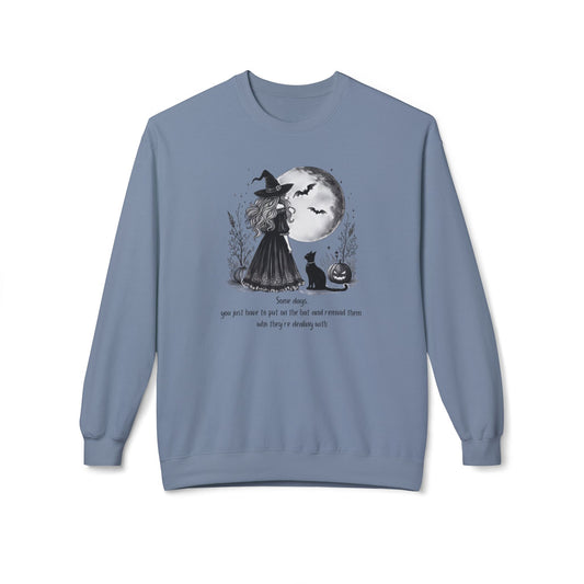 Blue sweatshirt with Halloween-themed design featuring a witch and moon on a white background