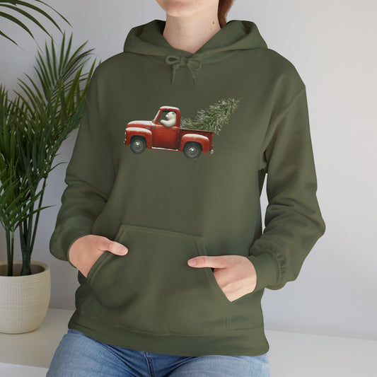 Person wearing a green hoodie with a red truck and Christmas tree design.
