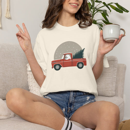 Person wearing a christmas tee with a polar bear and vintage truck.