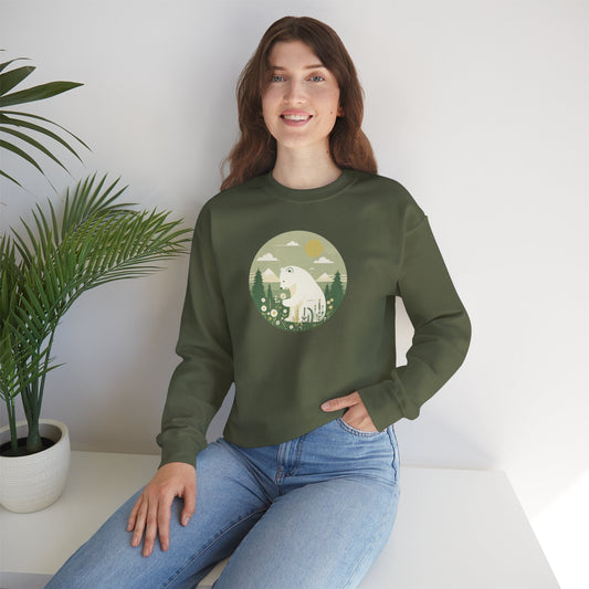 Woman wearing a green sweatshirt with a bear graphic sitting on a white surface with a plant in the background.
