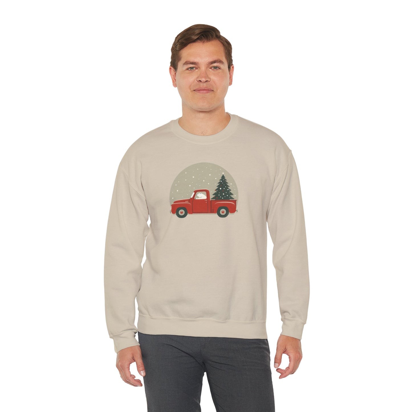 Man wearing a beige sweatshirt with a red truck and Christmas tree design on a white background