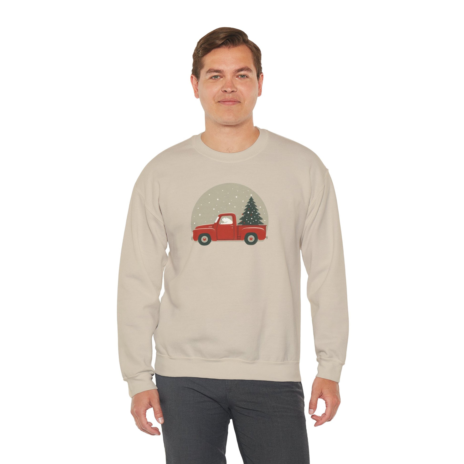 Man wearing a beige sweatshirt with a red truck and Christmas tree design on a white background