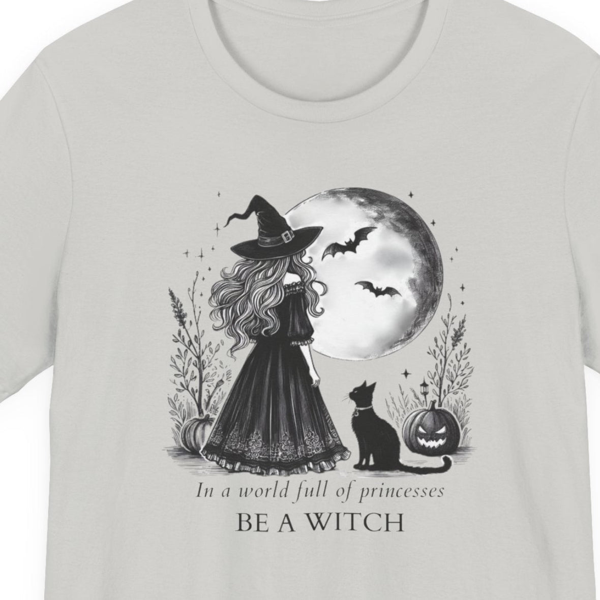 Gray t-shirt with a witch graphic and text on a white background