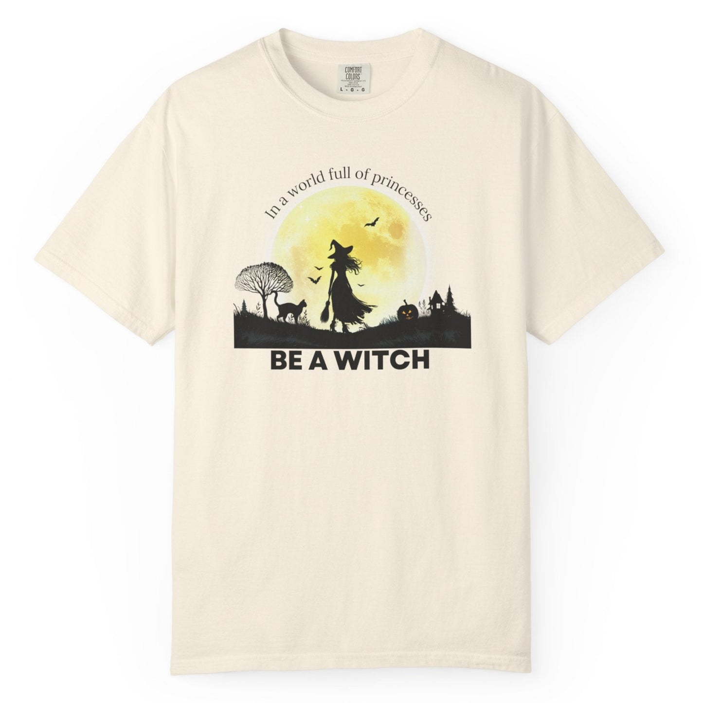 Beige t-shirt with a witch graphic and text on a white background