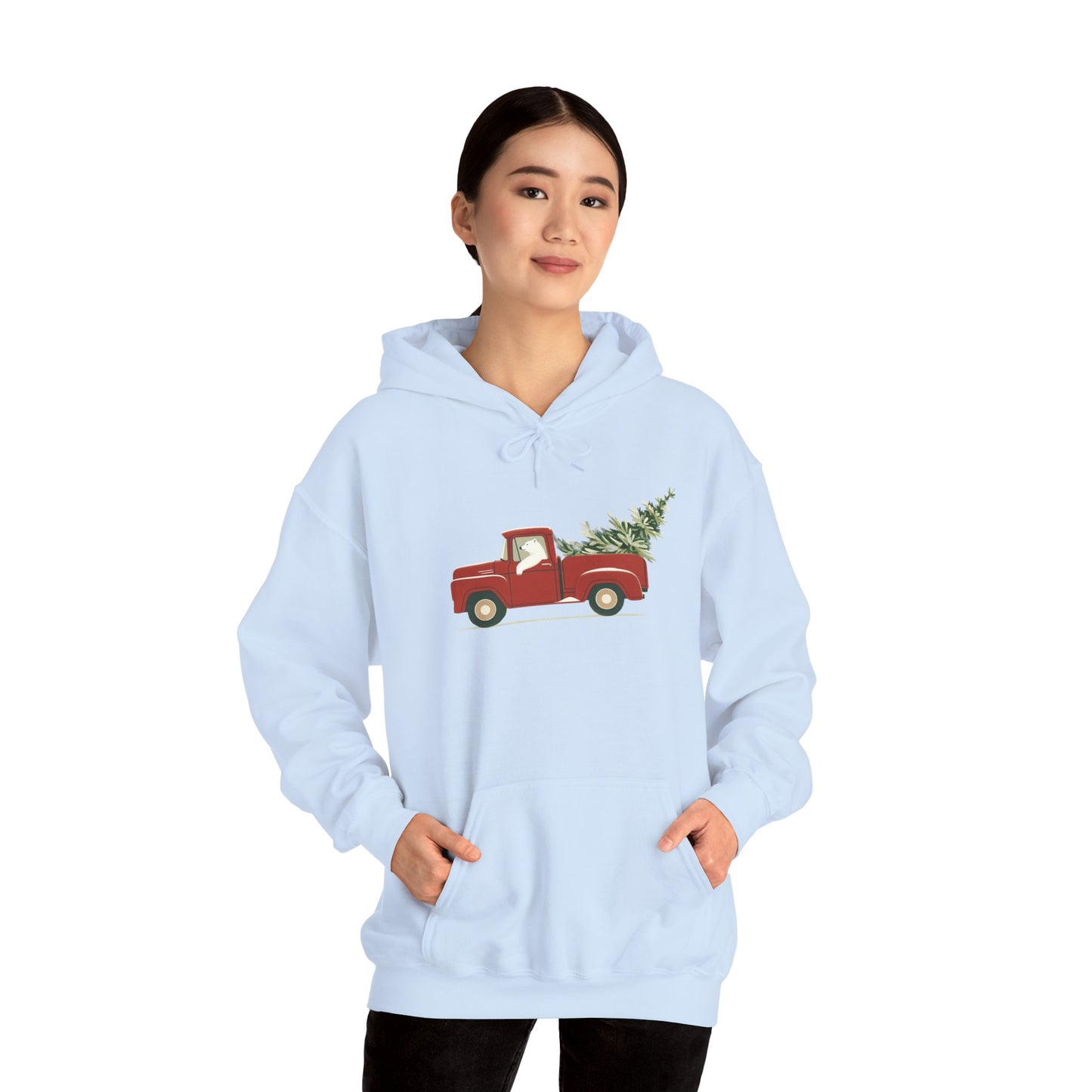 Light blue hoodie with a red truck and Christmas tree design worn by a person on a white background