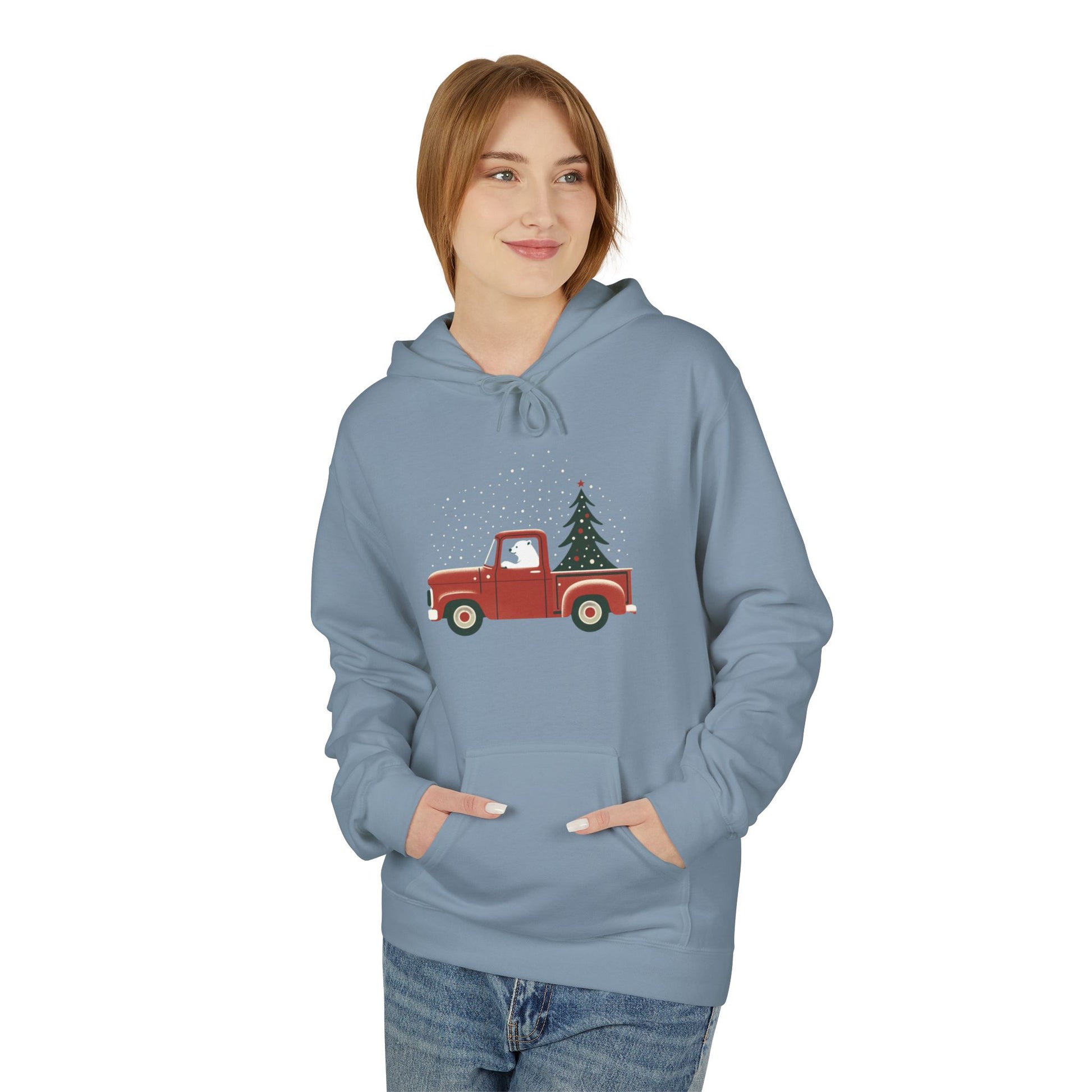 Person wearing a blue hoodie with a red truck and Christmas tree design on a white background