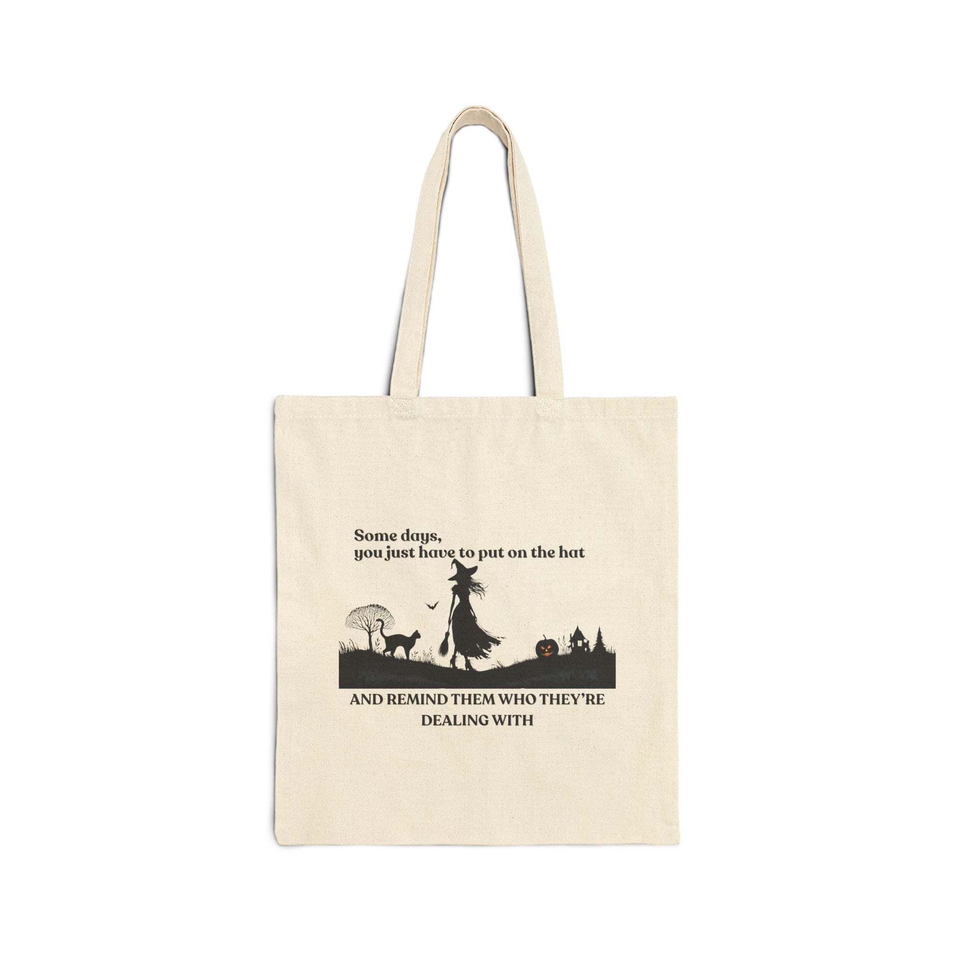 Beige tote bag with black witch and cat  silhouette design and text on a white background