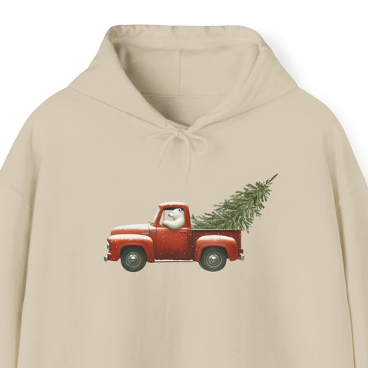 Beige hoodie with a graphic of a polar bear driving a red truck with a Christmas tree on a white background
