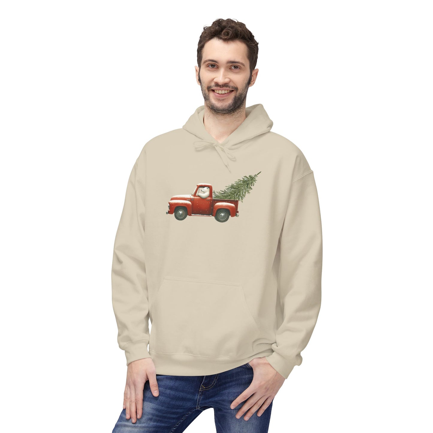 Man wearing a beige hoodie with a red truck and Christmas tree design on a white background