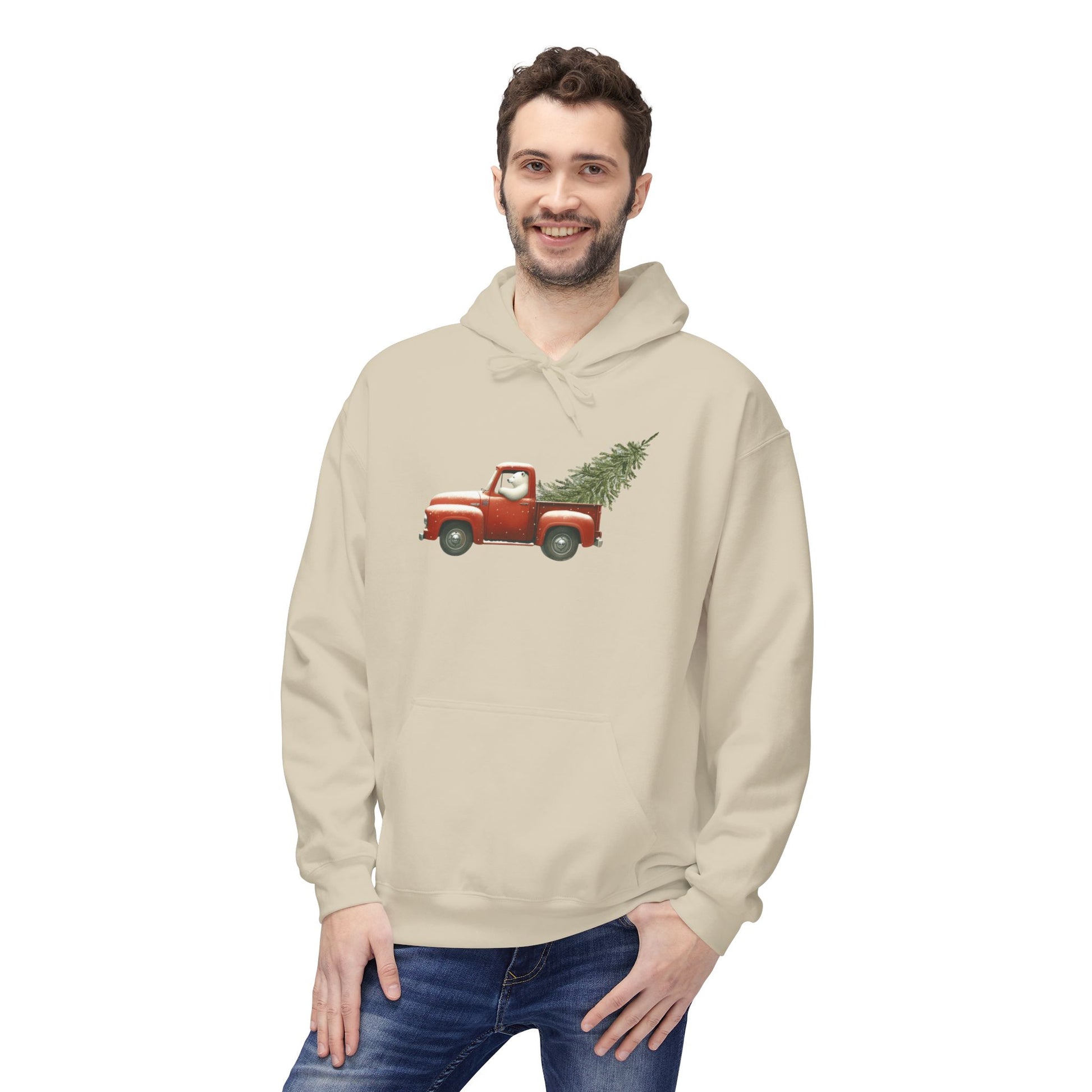 Man wearing a beige hoodie with a red truck and Christmas tree design on a white background