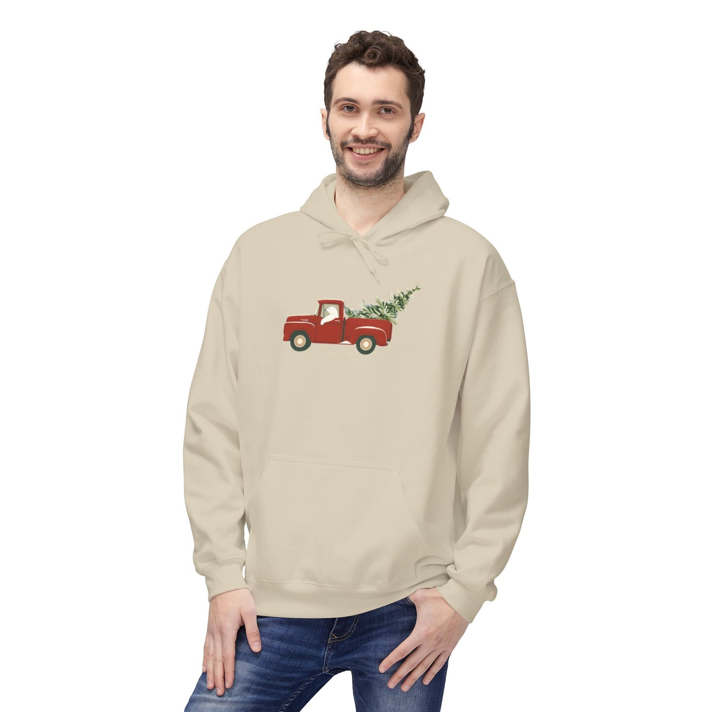 Man wearing a beige hoodie with a red truck and Christmas tree design on a white background