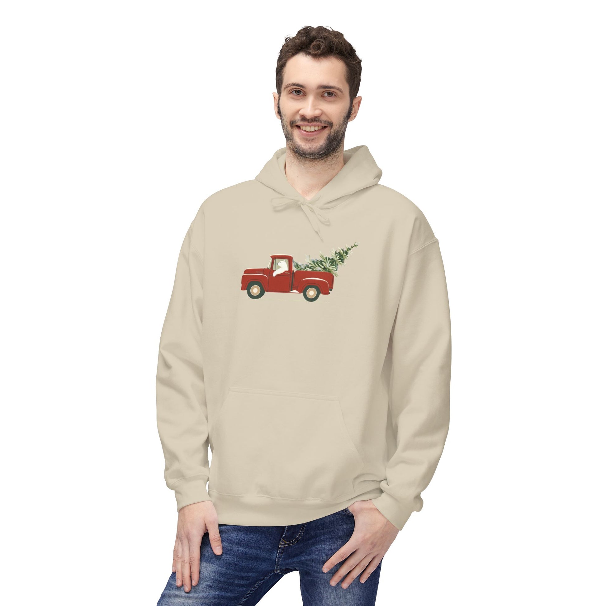 Man wearing a beige hoodie with a red truck and Christmas tree design on a white background
