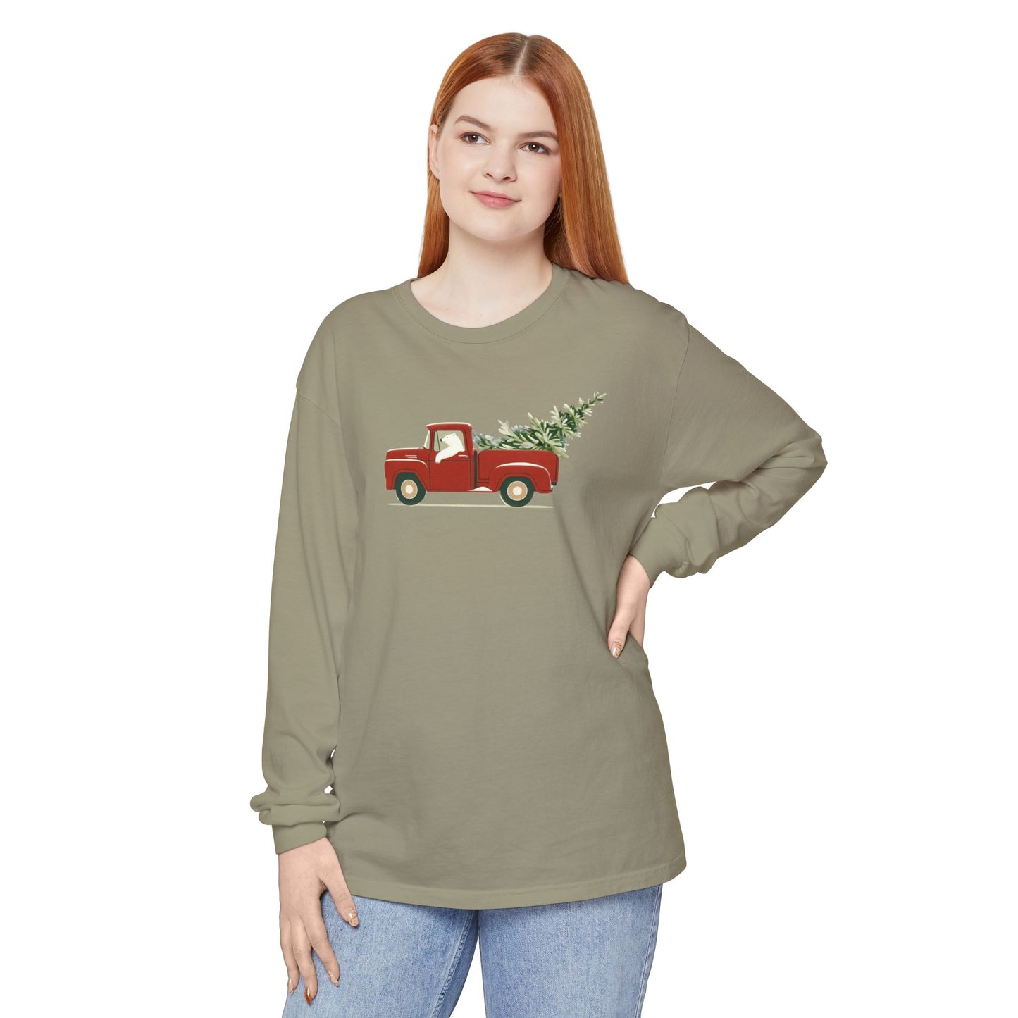 Woman wearing a green long-sleeve shirt with a red truck and Christmas tree graphic on a white background