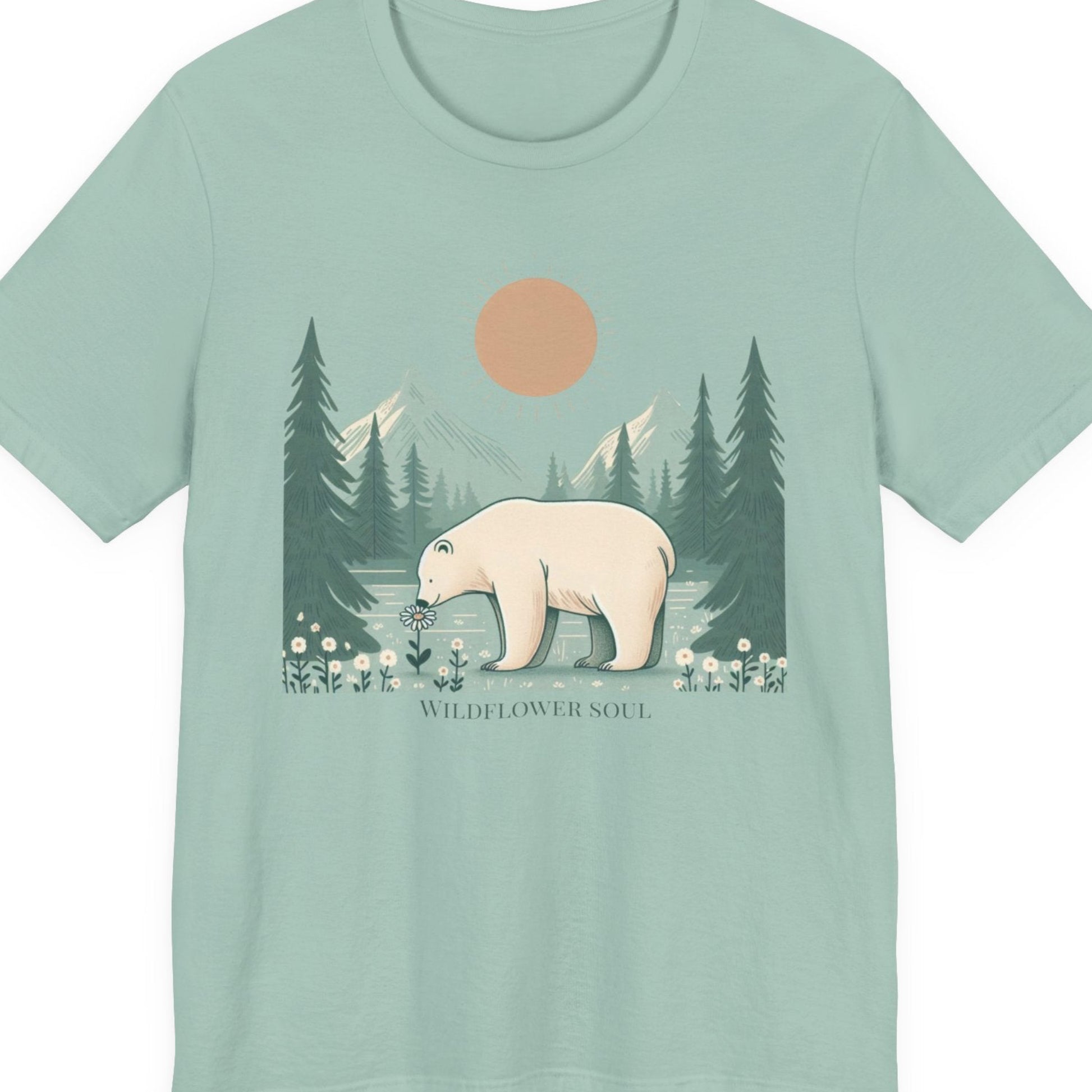 Mint green t-shirt with a bear and forest design on a white background