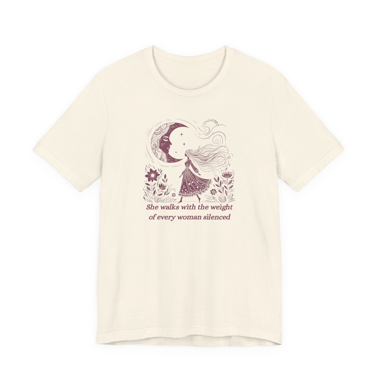 Empowering feminist t-shirt with illustrated woman walking under the moon, floral design, and the quote "She walks with the weight of every woman silenced.