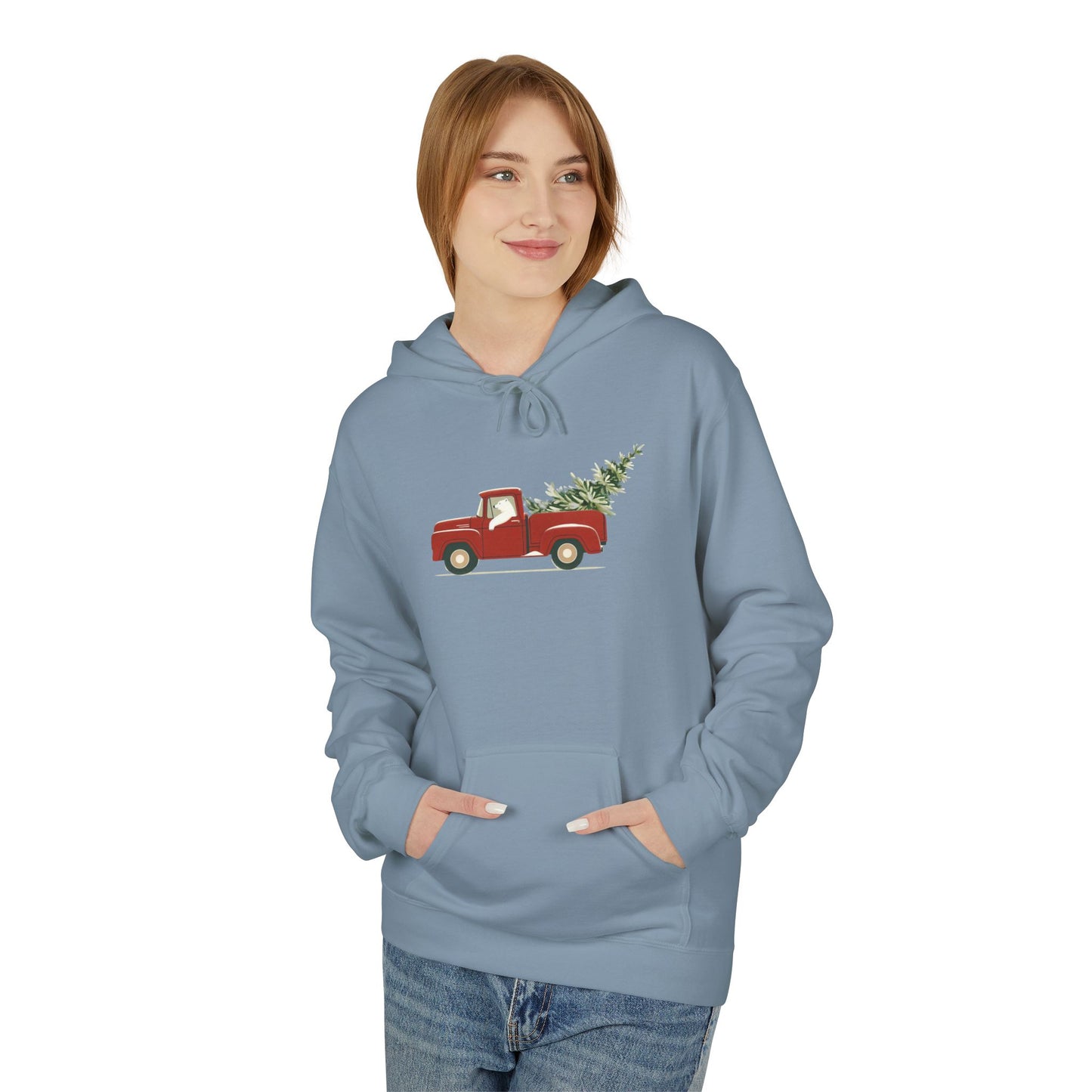 Person wearing a blue hoodie with a red truck and Christmas tree design on a white background