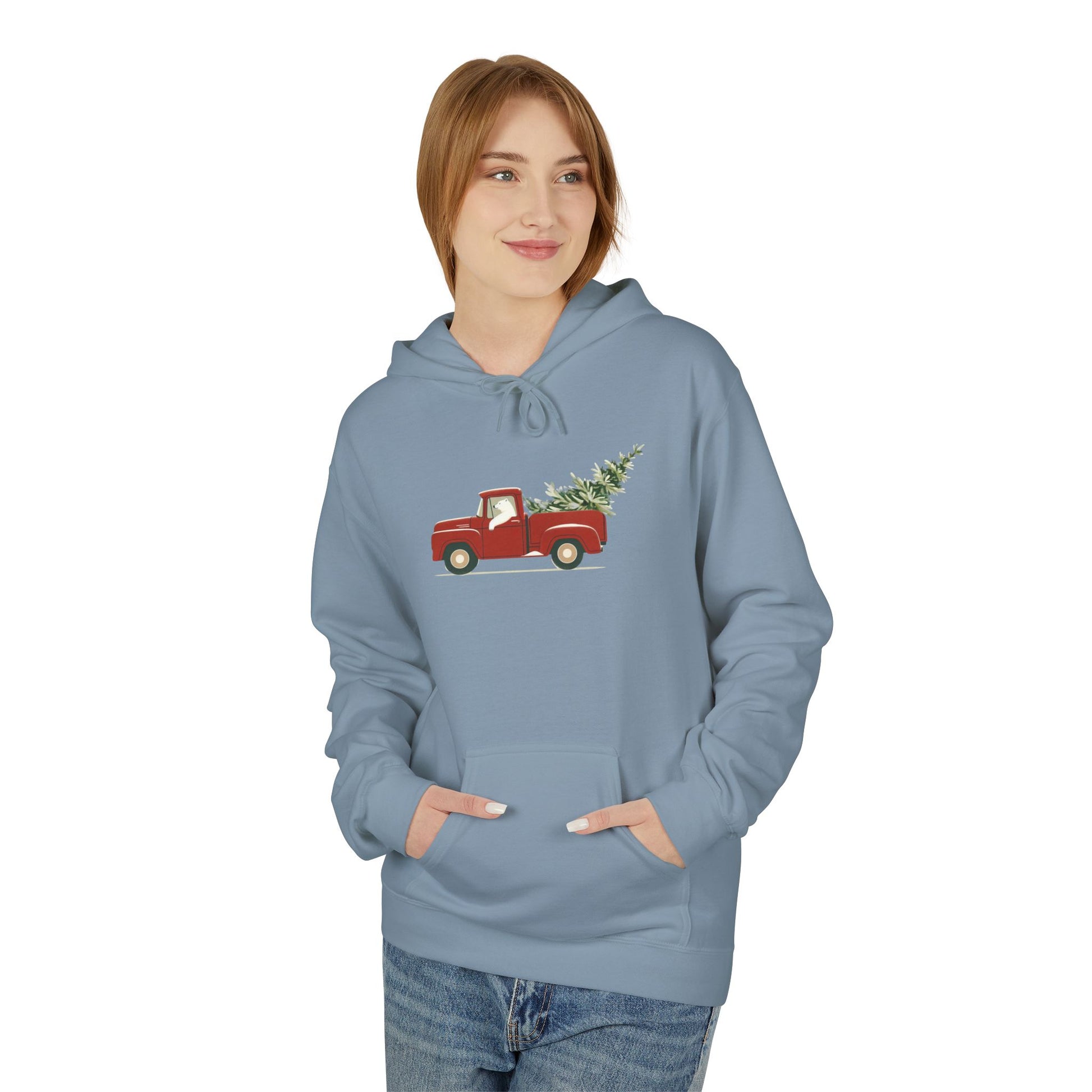 Person wearing a blue hoodie with a red truck and Christmas tree design on a white background