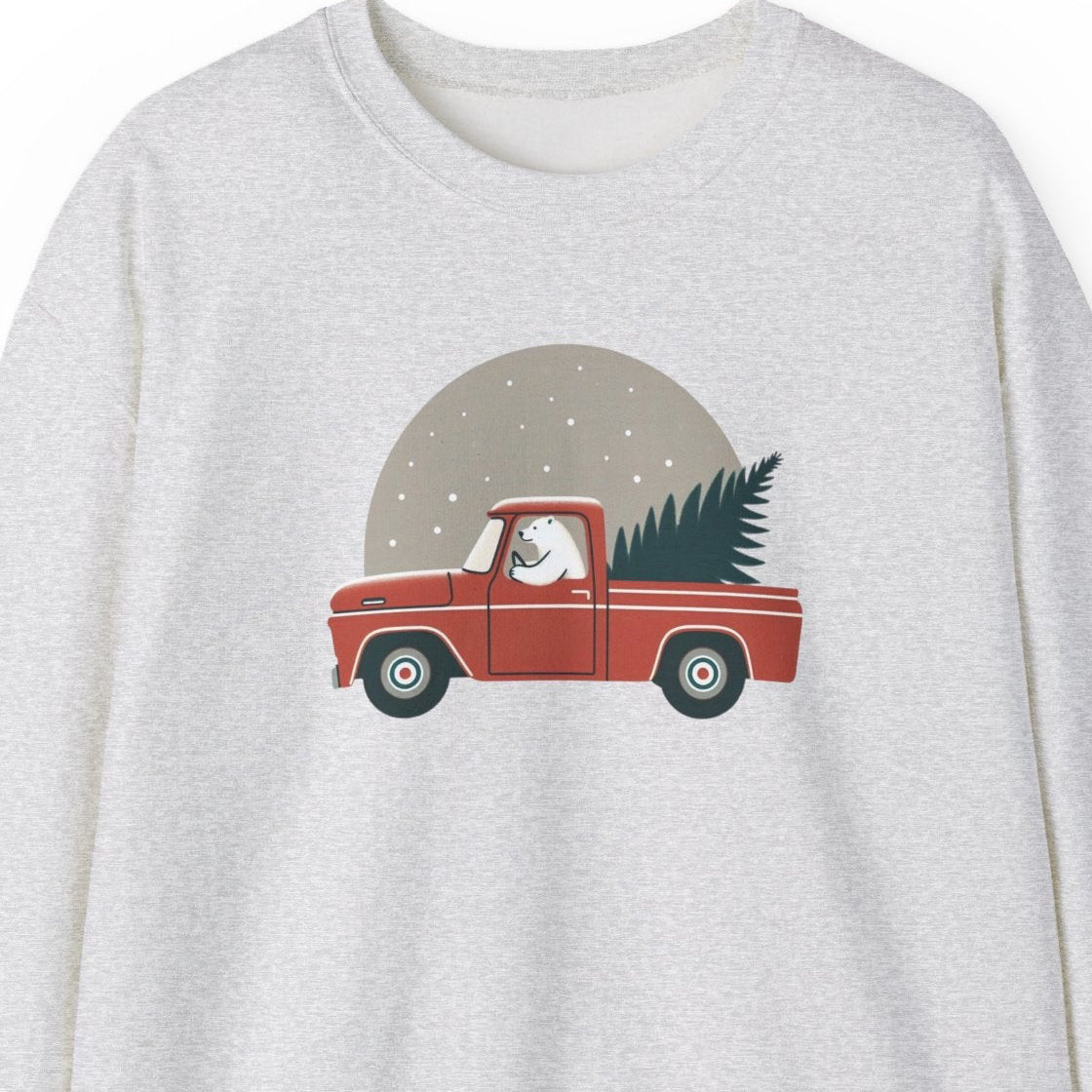 Gray sweatshirt with polar bear driving a red truck and Christmas tree graphic on a white background