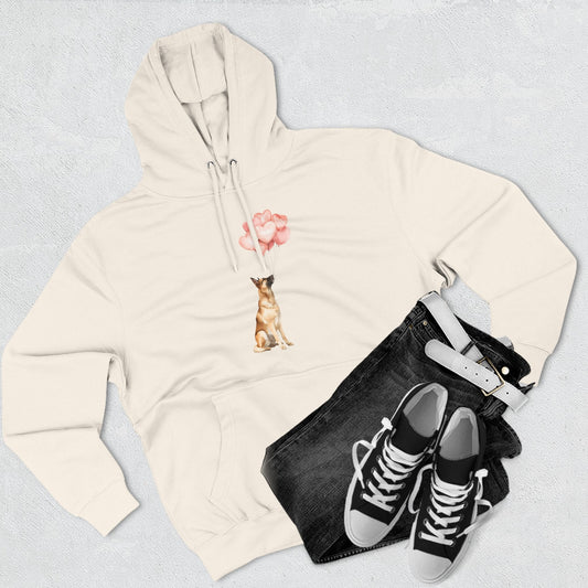 Beige hoodie with graphic design, black jeans, and black sneakers on a light gray background