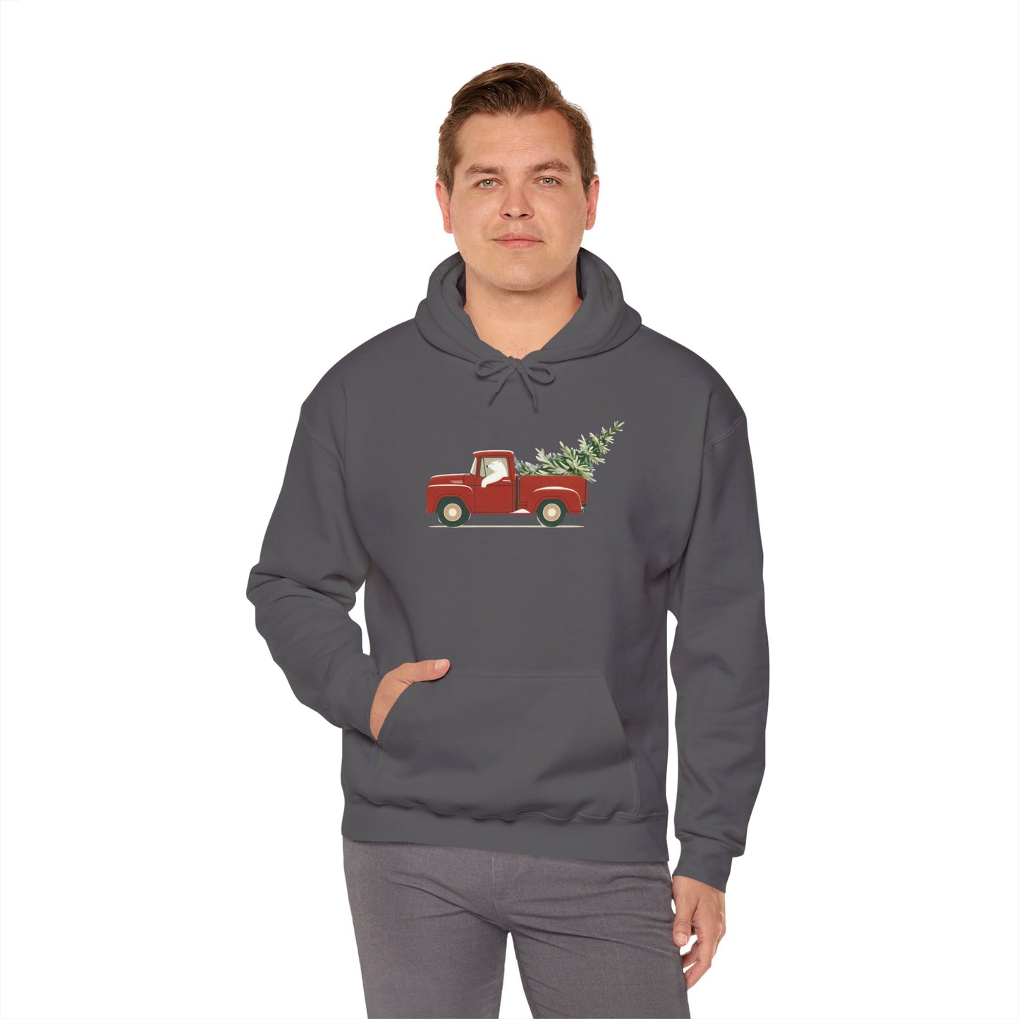 Person wearing a gray hoodie with a red truck and Christmas tree design on a white background