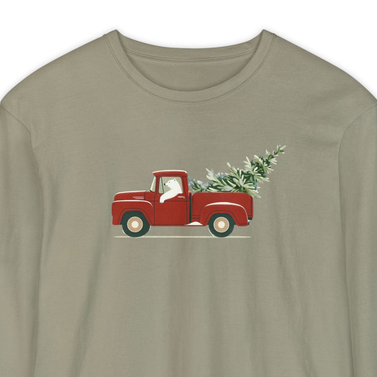 Khaki long-sleeve shirt with a polar bear driving a red truck and Christmas tree graphic on a white background