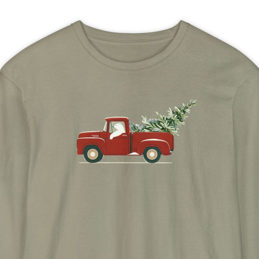 Khaki long-sleeve shirt with a polar bear driving a red truck and Christmas tree graphic on a white background