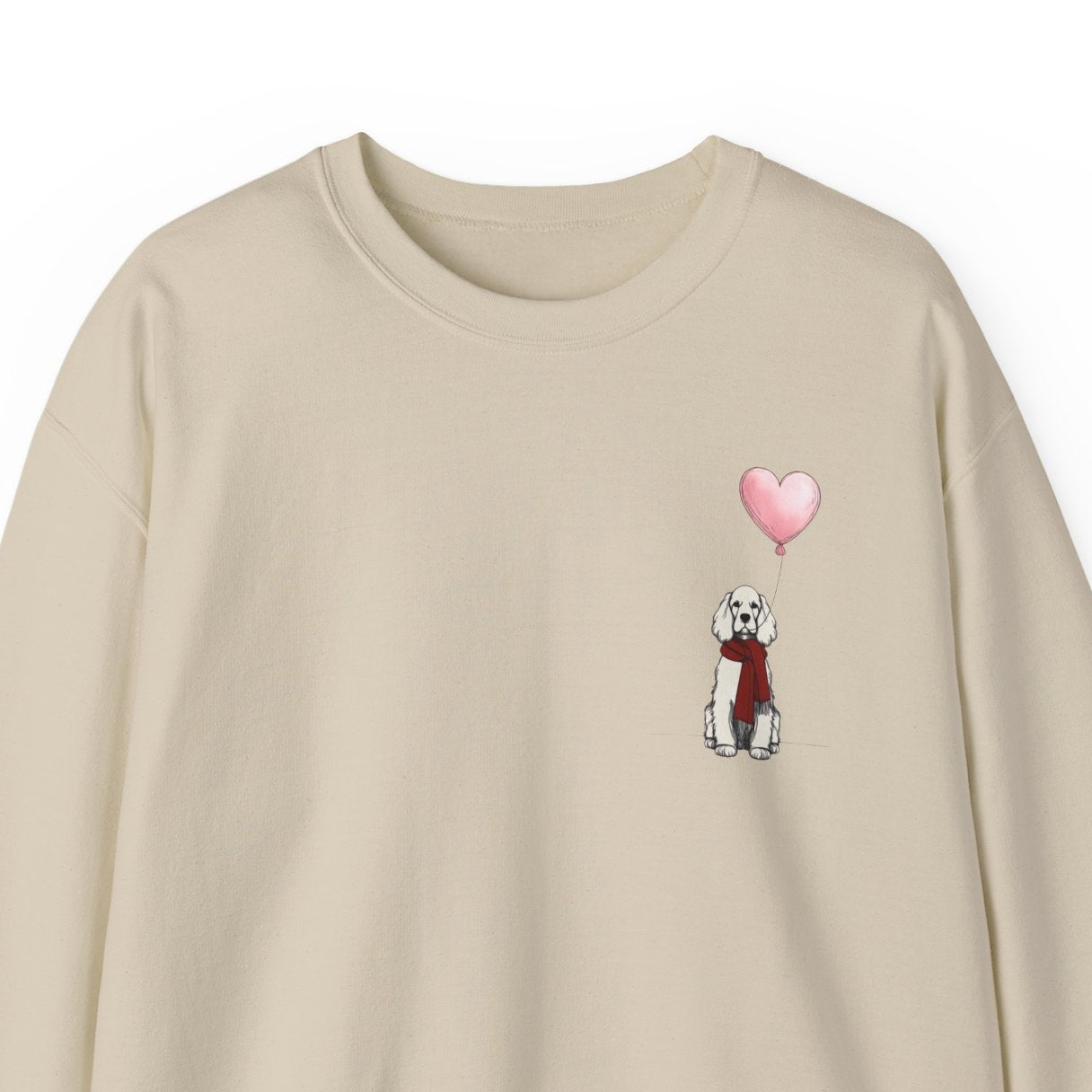 Beige sweatshirt with a small graphic of a Cocker Spaniel dog and heart balloon on a white background