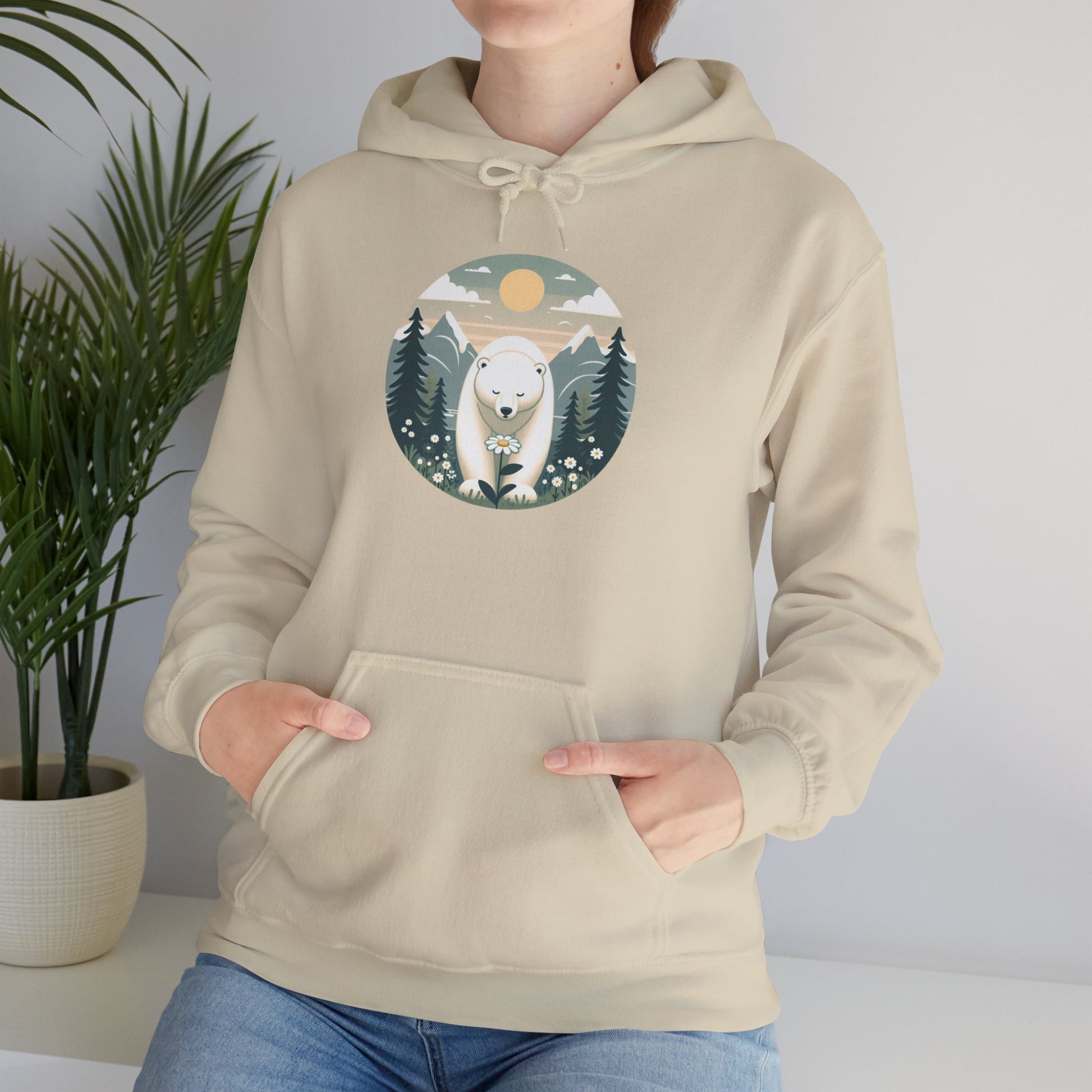 Person wearing a beige hoodie with a polar bear graphic on a plain background