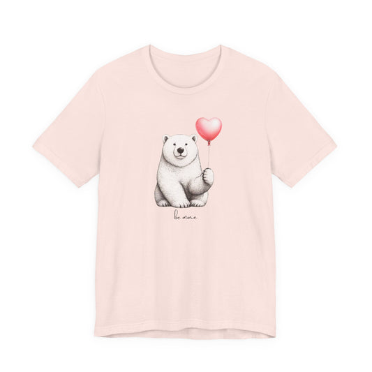 Pink t-shirt with a polar bear holding a heart-shaped balloon and 'be mine' text on a white background