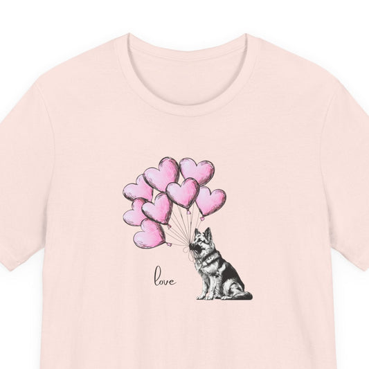 Pink t-shirt with a dog holding heart-shaped balloons and the word 'love' on a white background